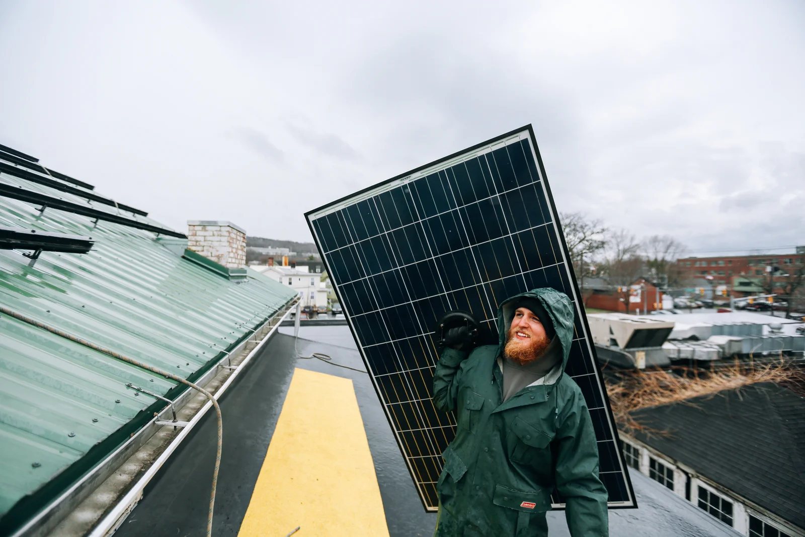 Technicien travaillant sur l'installation de panneaux solaires photovoltaïques sur un toit, vue rapprochée du raccordement des panneaux