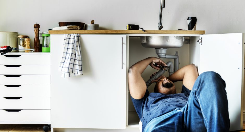 Plumber man fixing kitchen sink